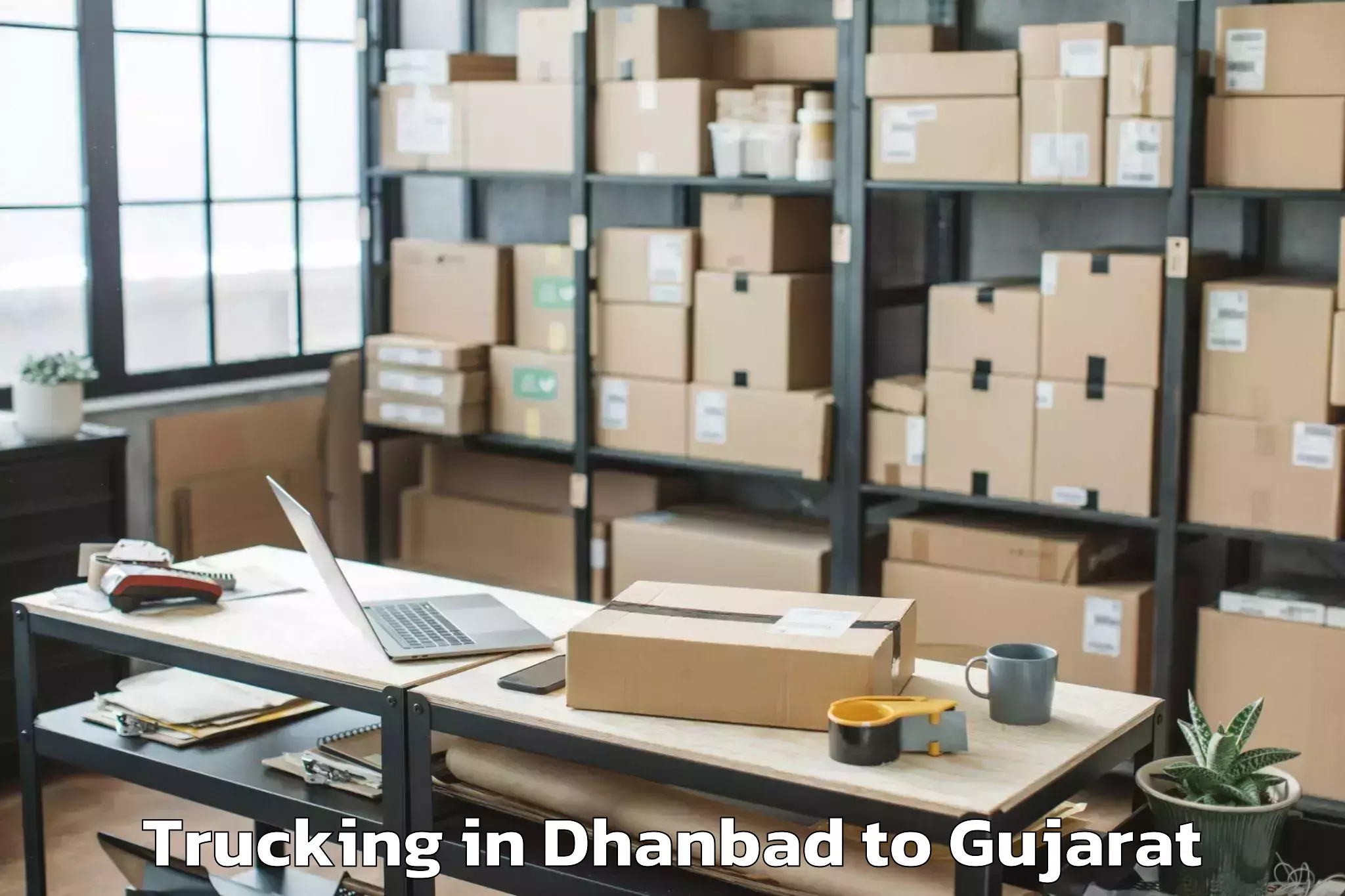 Easy Dhanbad to Dharmsinh Desai University Nad Trucking Booking